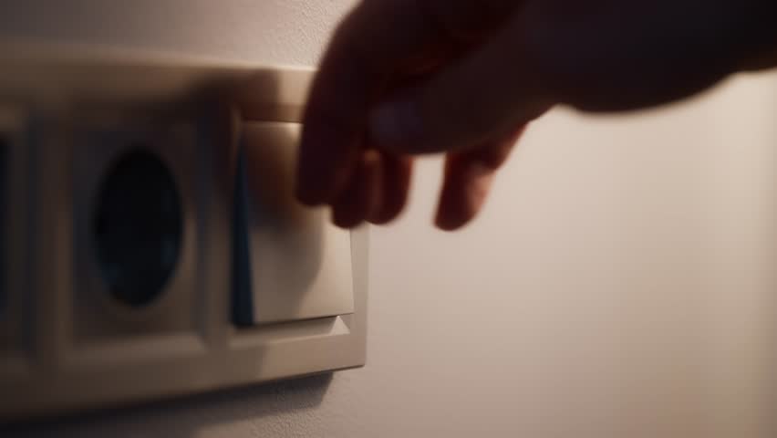 Woman Hands Turning On and Off a Wall Light Switch Close Up Shot of Fingers Pressing Switch in Modern Room Interior, Energy Control and Daily Routine Concept