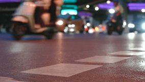 Close up of road surface marking on asphalt in Bangkok city at night rush hour. Blurred moving motorcycles and cars with bokeh lights in the background. Cinematic urban traffic scene - Powered by Shutterstock - Get 15% off with code: PIKWIZARD15