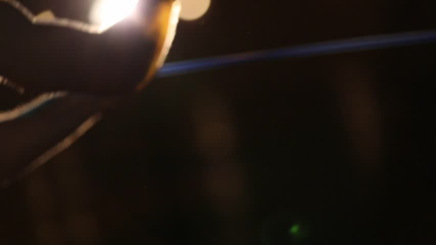 Low angle shot of woman performing intense battle rope exercises in a modern gym. Focus on dynamic rope movement for strength and cardio fitness training.