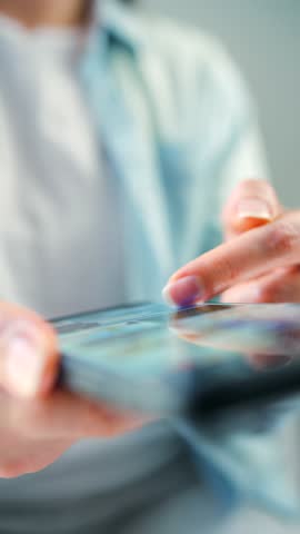 Woman scrolling through social media feeds on smartphone close up