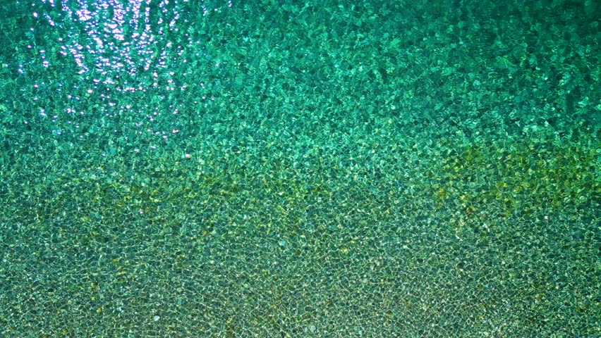 Top-down view of sea azure waves pattern and crystal clear water. Rhodes, Greece