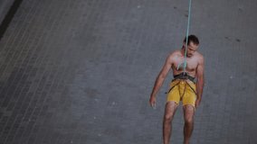 man climber descend down on rope after climbing challenging indoor wall route in modern climbing gym. extreme sport and mental focus. - Powered by Shutterstock - Get 15% off with code: PIKWIZARD15