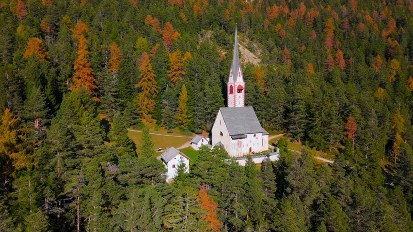 Church of St. Jacob with mountains in the background. Italy