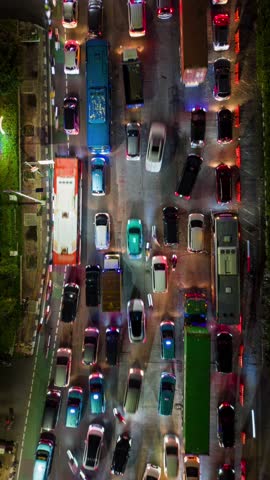 Aerial top-down timelapse of traffic jam on multi-lane road in Jakarta at night, Indonesia. Perfect for city, infrastructure, congestion, and transportation themes.
