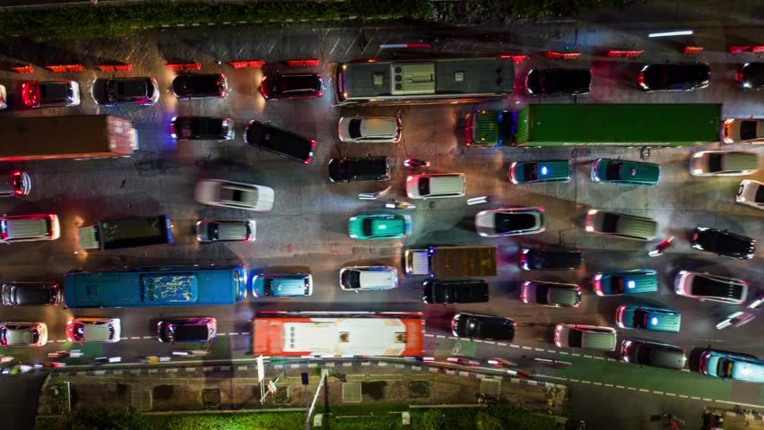 Aerial top-down timelapse of traffic jam on multi-lane road in Jakarta at night, Indonesia. Perfect for city, infrastructure, congestion, and transportation themes.
