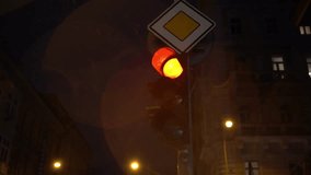 A traffic light glows through the rain, with water droplets and reflections adding mood and atmosphere to the urban street scene. - Powered by Shutterstock - Get 15% off with code: PIKWIZARD15