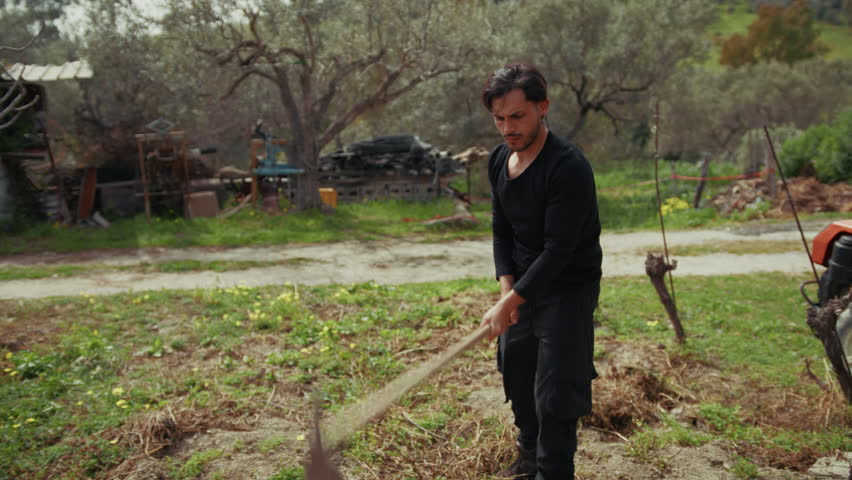 Sweating Man Working Hard With The Hoe 