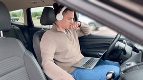 Mature businessman attending online meeting from car, using laptop and wireless headphones. Trustworthy remote worker concept. Business flexibility and efficiency. Side view. - Powered by Shutterstock - Get 15% off with code: PIKWIZARD15