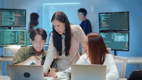 young Asian software development manager leads a late-night office discussion with his executive team, mentoring developers and analyzing source code to guide programming and project development - Powered by Shutterstock - Get 15% off with code: PIKWIZARD15