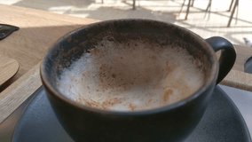 Cozy Cafe Moment with Frothy Cinnamon Coffee in Sunlit Setting Perfect for Relaxation and Inspiration - Powered by Shutterstock - Get 15% off with code: PIKWIZARD15