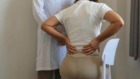 Female doctors hand rehab physical therapy by extending the pain back of patient, treatment with stretch exercises. - Powered by Shutterstock - Get 15% off with code: PIKWIZARD15