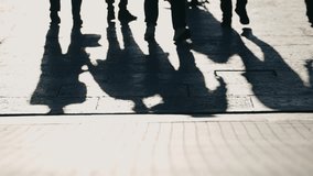 Shadows cast by business people walking on a sunlit paved street in the city financial district, concept video - Powered by Shutterstock - Get 15% off with code: PIKWIZARD15