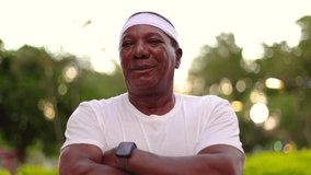 Senior black man in outdoor gym clothes. Arms crossed. White clothes and blurred background. - Powered by Shutterstock - Get 15% off with code: PIKWIZARD15