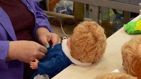 toy factory production assembly and packaging of plastic dolls for children - Powered by Shutterstock - Get 15% off with code: PIKWIZARD15