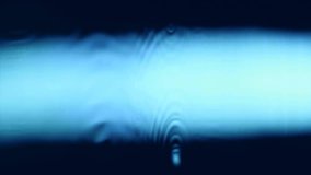 Hypnotic wave on high speed video shot in blue background. Vibrant effect liquid on surface water. Ripple and reflection aqua. Macro close up super slow motion 1000fps. Vibration liquid in blue color - Powered by Shutterstock - Get 15% off with code: PIKWIZARD15
