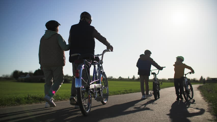 Evening return to home family walk with grandchildren and their grandparents 