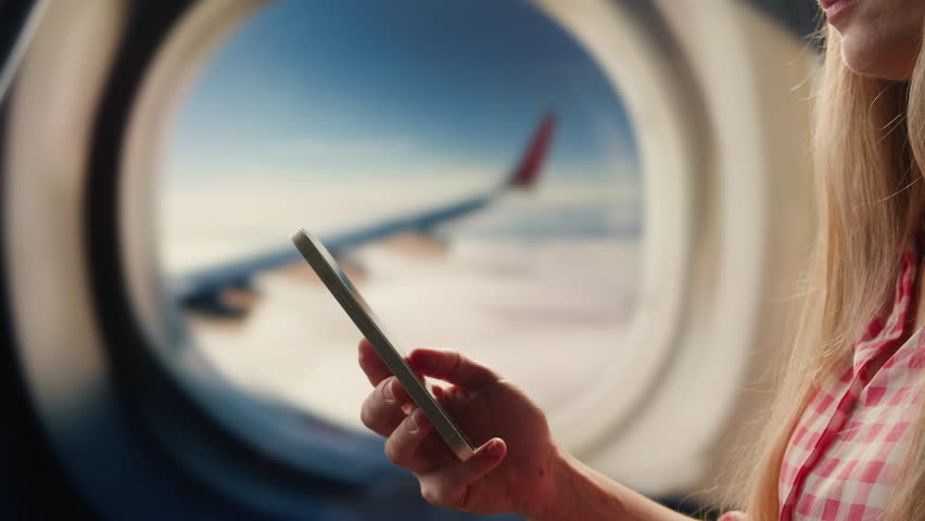 Using phone and tablet pc on airplane in air, Hands of traveller using smartphone for connecting, using app. Tourist waiting for boarding for vacation in airport. Green screen concept.