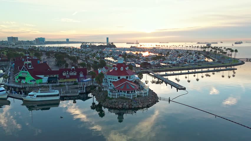 Aerial view of Lions Lighthouse at sunrise, revealing calm waters and distant ships in Long Beach, California.