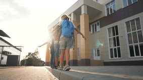 Happy family concept. portrait of children going to school. children with backpacks run on way to school. students go together to receive an education. children's dream. students smiling holding hands - Powered by Shutterstock - Get 15% off with code: PIKWIZARD15