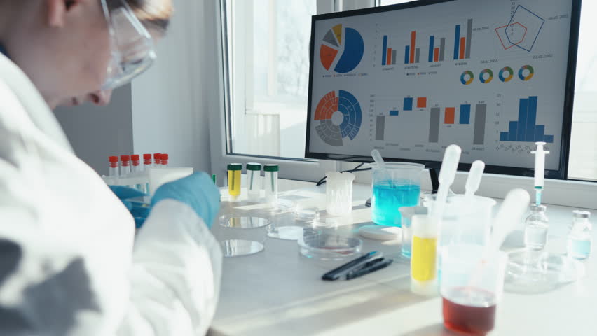 A dedicated scientist in a white lab coat is analyzing samples and complex data on a hightech screen, highlighting advancements in medical sciences, particularly in innovative vaccine development - Powered by Shutterstock - Get 15% off with code: PIKWIZARD15