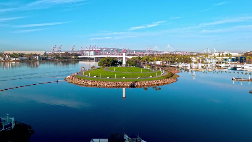Tranquil beauty of Lions Lighthouse and ShoreLine Aquatic Park in Long Beach, CA at dawn with calm waters creating perfect reflections
