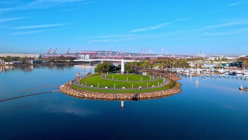 Tranquil beauty of Lions Lighthouse and ShoreLine Aquatic Park in Long Beach, CA at dawn with calm waters creating perfect reflections