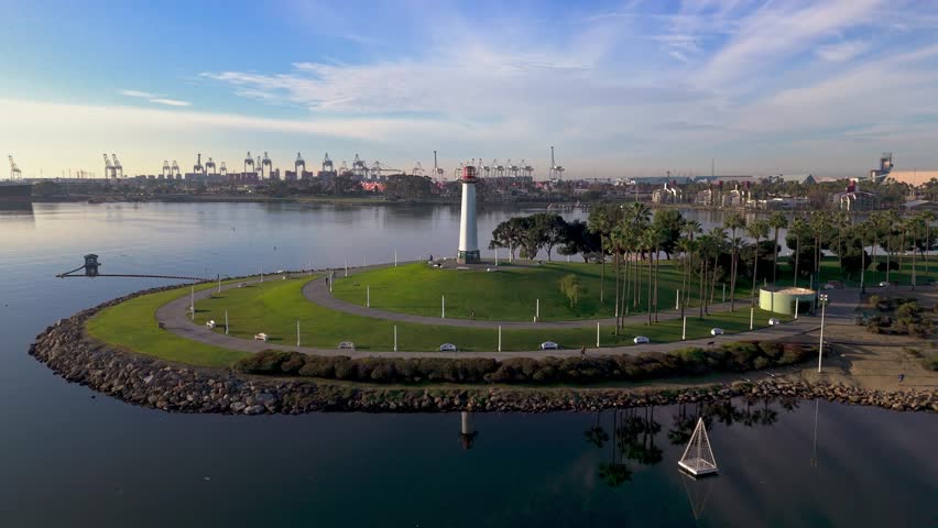 Iconic Lions Lighthouse aerial orbit shot at dawn with downtown Long Beach, CA skyline in the background