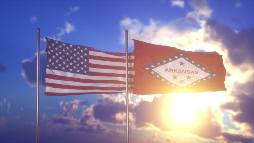 United States and Arkansas Flags Waving Together at Golden Sunset