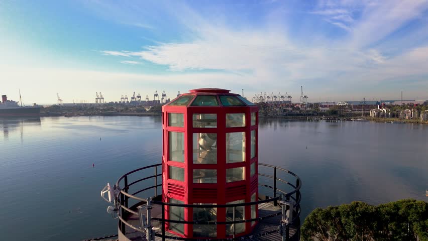 Beautiful Lions Lighthouse and ShoreLine Aquatic Park in Long Beach, CA at dawn with calm waters creating perfect reflections