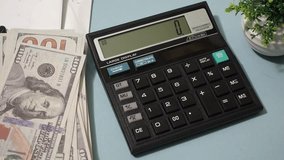 Woman hands pressing calculator buttons analyzing business income. Accountant working at table with documents bills money cash - Powered by Shutterstock - Get 15% off with code: PIKWIZARD15
