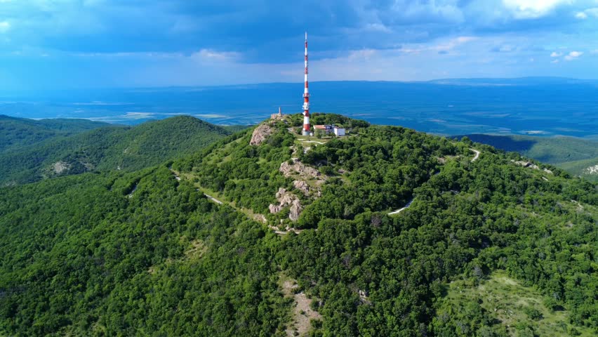 Drone view of the TV tower on Peak Sheynovets in the Rhodope Mountains, Bulgaria. Surrounded by dense forests, it offers impressive panoramic views of the region.