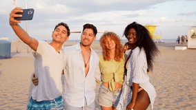 Diverse group of young friends capturing vacation memories while taking selfies, laughing and enjoying sunset moments on tropical beach shoreline - Powered by Shutterstock - Get 15% off with code: PIKWIZARD15