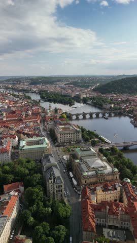 Vertical Aerial View of Prague with Vltava River on a Clear Afternoon.