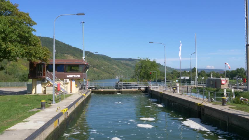 Water flows into wintrich lock, regulating the water level of the moselle river in germany