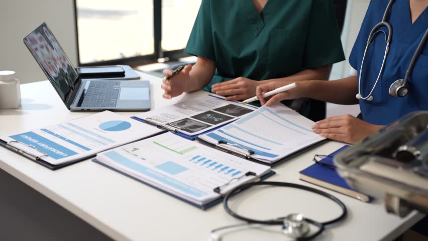 Medical team working with a tablet and Laptop computer search for medical information at the hospital office. - Powered by Shutterstock - Get 15% off with code: PIKWIZARD15