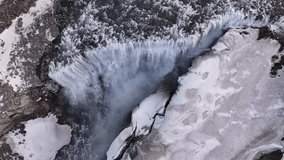 Aerial winter view of Dettifoss, Europe's most powerful waterfall, thundering through icy cliffs in Iceland's Vatnajökull National Park. - Powered by Shutterstock - Get 15% off with code: PIKWIZARD15