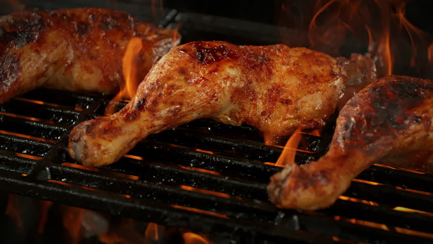 Super Slow Motion Shot of Chicken Legs on Fired Up Grill with Camera Motion at 1000fps.