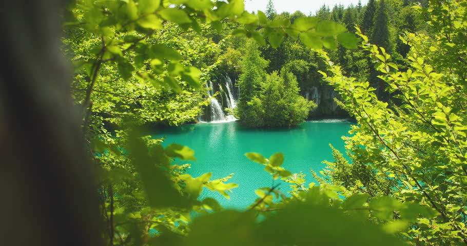 Scenic view of Plitvice Lakes waterfalls in Croatia surrounded by lush greenery
