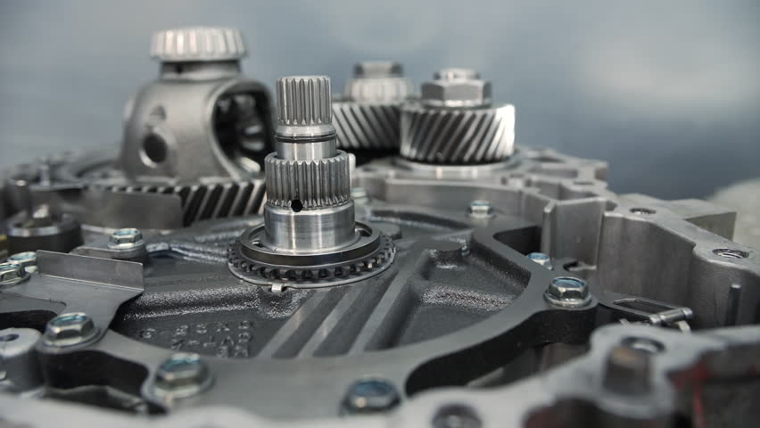 Exposed gear shafts inside disassembled automotive transmission