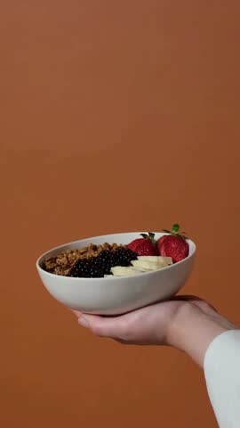 4K Close-Up Video of Woman’s Hand Holding a Smoothie Bowl – Healthy Food and Lifestyle