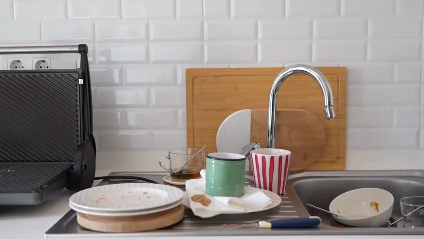 4K Ultra HD Video of Messy Kitchen Sink with Uncleaned Dishes and Running Water – Household Chore and Real Life Concept