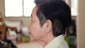 Close-up side view of a senior woman adjusting her behind-the-ear hearing aid at home, illustrating hearing loss support, elderly care, and accessibility for better quality of life and wellness. - Powered by Shutterstock - Get 15% off with code: PIKWIZARD15