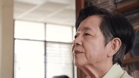 Side profile of a senior woman using her finger to adjust a hearing aid at home, representing hearing care, elder wellness, and assistive technology for improved communication and daily living. - Powered by Shutterstock - Get 15% off with code: PIKWIZARD15