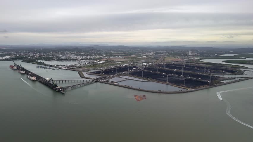 Overcast aerial approaches Gladstone coal terminal in QLD Australia
