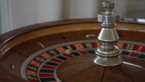 The roulette wheel slows down and the ball finally lands on 30 red. A moment of tension and anticipation in the elegant casino interior. High quality 4k footage - Powered by Shutterstock - Get 15% off with code: PIKWIZARD15