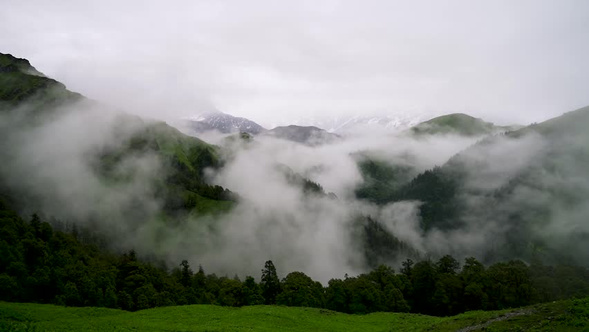 Timelapse of mountains landscape valley in summer daytime with clouds