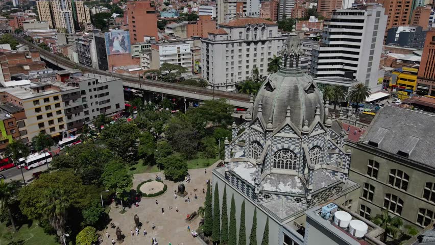 An ascending drone footage of the urban buildings at the downtown of Medellin city, in the mountainous Antioquia province in Colombia on a sunny day