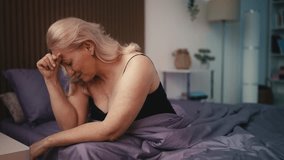 Stressed middle-aged woman feeling frustrated while sitting on bed, problems - Powered by Shutterstock - Get 15% off with code: PIKWIZARD15