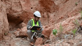 A geologist is examining the mineral content of soil and recording it on paper - Powered by Shutterstock - Get 15% off with code: PIKWIZARD15