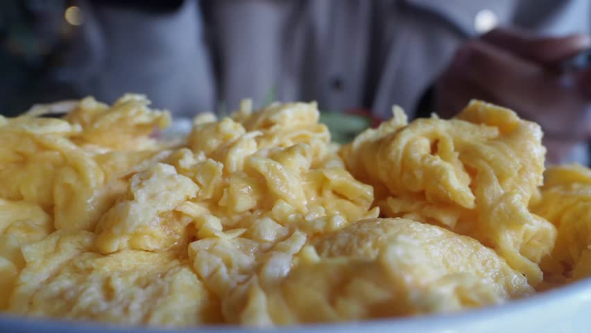 Close-Up of Creamy Scrambled Eggs in a Ceramic Serving Bowl